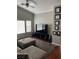 Living room with hardwood floors, neutral walls, and entertainment setup at 8811 Tomnitz Ave # 101, Las Vegas, NV 89178