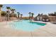 Community pool features palm trees, lounge chairs, and clear blue water at 8811 Tomnitz Ave # 101, Las Vegas, NV 89178