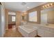 Well-lit bathroom featuring double sinks, a soaking tub, and a separate shower at 8988 Winchester Ridge St, Las Vegas, NV 89139