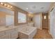 Well-lit bathroom featuring double sinks, a soaking tub, and a separate shower at 8988 Winchester Ridge St, Las Vegas, NV 89139