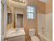 Well-lit bathroom with a single vanity, toilet, and shower/tub, featuring clean lines and functional design at 8988 Winchester Ridge St, Las Vegas, NV 89139