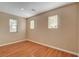 Well-lit bedroom with hardwood flooring and natural light from multiple windows at 8988 Winchester Ridge St, Las Vegas, NV 89139