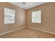 Cozy bedroom with two windows providing natural light and neutral paint, complemented by tile flooring at 8988 Winchester Ridge St, Las Vegas, NV 89139