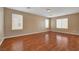 Spacious bedroom with wood floors, recessed lighting, and multiple windows offering ample natural light at 8988 Winchester Ridge St, Las Vegas, NV 89139