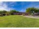 Well-maintained community park with lush green grass, mature trees, and walking path at 8988 Winchester Ridge St, Las Vegas, NV 89139