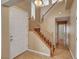 Inviting home entryway featuring a staircase with wood banister and a clear view into the adjacent living space at 8988 Winchester Ridge St, Las Vegas, NV 89139