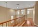 Bright hallway with wood floors and an elegant wooden railing staircase at 8988 Winchester Ridge St, Las Vegas, NV 89139