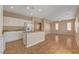 Open kitchen featuring white cabinets, granite countertops, stainless appliances, and an island with sink at 8988 Winchester Ridge St, Las Vegas, NV 89139