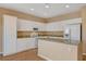 Bright kitchen with white cabinets, granite countertops, stainless appliances, and an island with a sink at 8988 Winchester Ridge St, Las Vegas, NV 89139