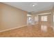 The living room is warm and inviting with neutral walls, bright lighting, and ceramic tile flooring at 8988 Winchester Ridge St, Las Vegas, NV 89139