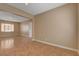 Spacious living room with neutral paint and tile flooring is illuminated by natural light from the window at 8988 Winchester Ridge St, Las Vegas, NV 89139