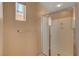 Modern bathroom shower with glass door and chrome fixtures with window, offering natural light at 8988 Winchester Ridge St, Las Vegas, NV 89139