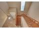 Bright foyer and staircase with wooden steps and railing, bathed in natural light from a skylight at 8988 Winchester Ridge St, Las Vegas, NV 89139
