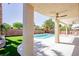 Lush backyard with a private pool, covered patio, and beautiful landscaping at 901 Sir Winston St, Henderson, NV 89052