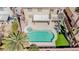 Aerial view of the pool, spa, and patio in the backyard, surrounded by lush greenery and palms at 901 Sir Winston St, Henderson, NV 89052