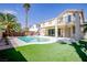 Stunning backyard featuring a pool, spa, and lush green turf, perfect for outdoor entertaining at 901 Sir Winston St, Henderson, NV 89052