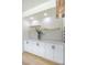 Modern bar area with white cabinets, marble countertops, and gold accents at 901 Sir Winston St, Henderson, NV 89052