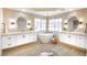 Elegant bathroom with dual sinks, standalone tub, and modern fixtures at 901 Sir Winston St, Henderson, NV 89052