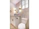 Chic bathroom featuring modern vanity with marble countertop, stylish mirror and lighting, with toilet on the side at 901 Sir Winston St, Henderson, NV 89052