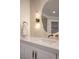 Detailed view of a bathroom vanity, unique mirror and fixtures at 901 Sir Winston St, Henderson, NV 89052