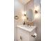 Stylish powder room with elegant marble countertop, modern fixtures, and unique oval mirror at 901 Sir Winston St, Henderson, NV 89052