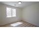 Bright bedroom with large window showcasing outdoor scenery and light wooden floors at 901 Sir Winston St, Henderson, NV 89052