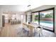 Open concept dining area with seamless flow to a modern kitchen and a view of the pool at 901 Sir Winston St, Henderson, NV 89052