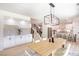 Light-filled dining room with modern decor open to kitchen and stairs at 901 Sir Winston St, Henderson, NV 89052