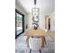 Dining room with a modern light fixture, table, and six chairs at 901 Sir Winston St, Henderson, NV 89052