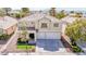 Charming two-story home with a well-maintained front yard and two-car garage at 901 Sir Winston St, Henderson, NV 89052