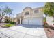 Inviting two-story home with a neutral exterior and a spacious two-car garage at 901 Sir Winston St, Henderson, NV 89052