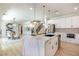 Modern kitchen with white cabinetry, stainless steel appliances, and a large marble island at 901 Sir Winston St, Henderson, NV 89052