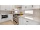 Bright, modern kitchen with white cabinets, stainless steel appliances and marble countertops at 901 Sir Winston St, Henderson, NV 89052