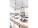 Close up of the beautiful kitchen island with a marble countertop, black faucet, and stylish pendant lights at 901 Sir Winston St, Henderson, NV 89052
