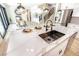 Modern kitchen with stainless appliances and large island opens to living area at 901 Sir Winston St, Henderson, NV 89052