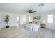 Bright main bedroom featuring light wood floors, a ceiling fan, and art at 901 Sir Winston St, Henderson, NV 89052