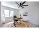 Bright home office with wood desk, jute rug, modern fan, and lots of natural light at 901 Sir Winston St, Henderson, NV 89052