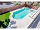Aerial view of a backyard oasis with a sparkling pool, spa, and lush landscaping at 901 Sir Winston St, Henderson, NV 89052