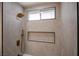 Elegant bathroom shower with modern bronze fixtures and niche at 901 Sir Winston St, Henderson, NV 89052