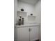 Bathroom storage cabinet with a marble top and floating shelves for decor at 901 Sir Winston St, Henderson, NV 89052