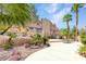 Lush backyard oasis with towering palms, desert landscaping, and a stylish outdoor dining area at 912 Santa Ynez Ave, Henderson, NV 89002