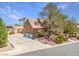Beautiful home with multiple garages, desert landscaping, and a spacious concrete driveway at 912 Santa Ynez Ave, Henderson, NV 89002