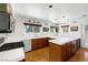 Well-lit kitchen with white tile countertops, wood cabinetry, and stainless steel appliances at 912 Santa Ynez Ave, Henderson, NV 89002