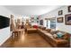 Spacious living area with wood floors, a large sectional couch, and multiple windows at 912 Santa Ynez Ave, Henderson, NV 89002