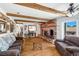 Cozy living room features exposed beams, wood floors, a brick fireplace, and comfortable seating at 912 Santa Ynez Ave, Henderson, NV 89002
