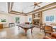 Open living area with a stone fireplace, pool table, and comfortable seating arrangements at 912 Santa Ynez Ave, Henderson, NV 89002