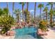Sparkling pool with rock waterfall and lush landscaping at 912 Santa Ynez Ave, Henderson, NV 89002