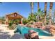 Lush pool area with rock features and palm trees at 912 Santa Ynez Ave, Henderson, NV 89002