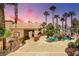 Stunning pool with a rock waterfall feature, lush landscaping, and a covered patio area at 912 Santa Ynez Ave, Henderson, NV 89002