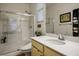Bright bathroom featuring a shower, neutral-toned cabinets, solid surface counters, and an undermount sink at 1000 E Sunset Rd, Henderson, NV 89011